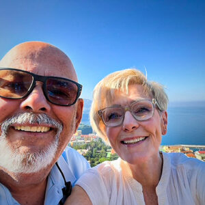 John and Linda Bernal post infront of an ocean view