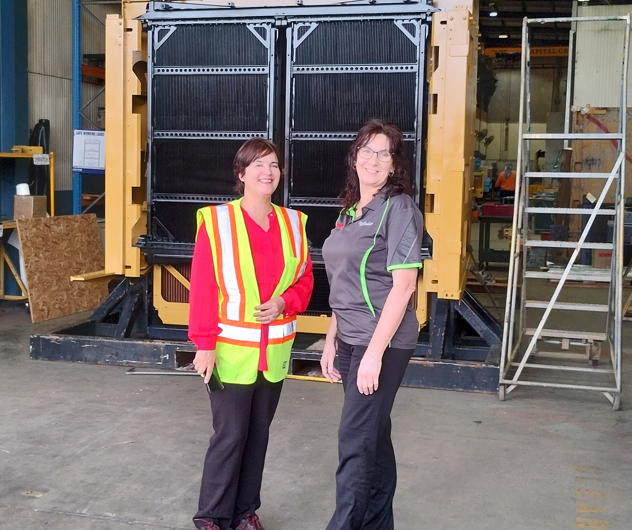 two women stand in front of a mesabi radiator