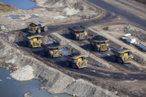 Loaders hauling oil sands material in the fields.