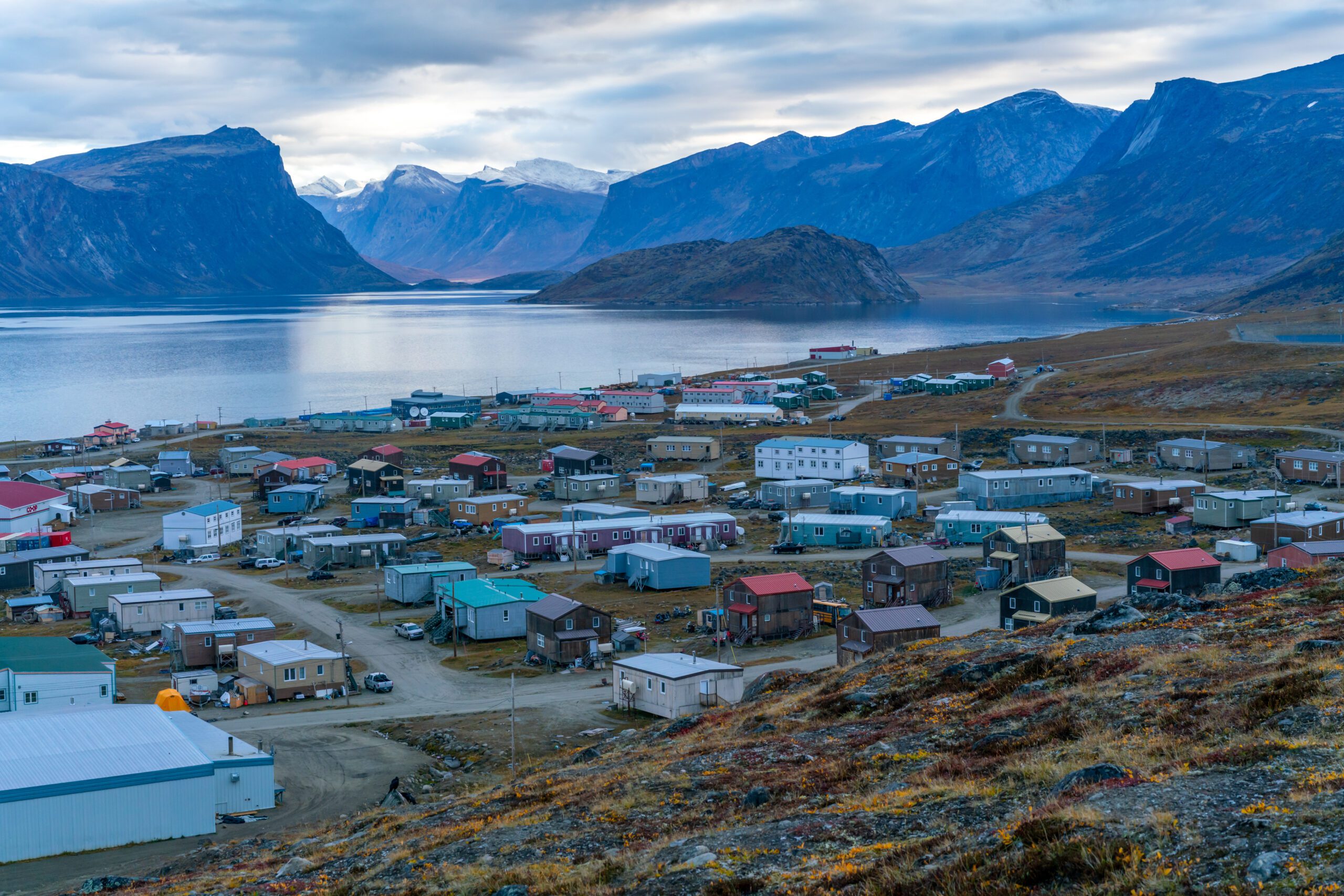 An early morning sunrise appears above a remote community in Pangnirtung, Nunavut, Canada.